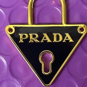 Prada Black and Gold Triangle Lock Pendant.